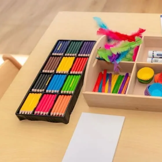 Trays of coloured pencils and craft materials ready for drawing