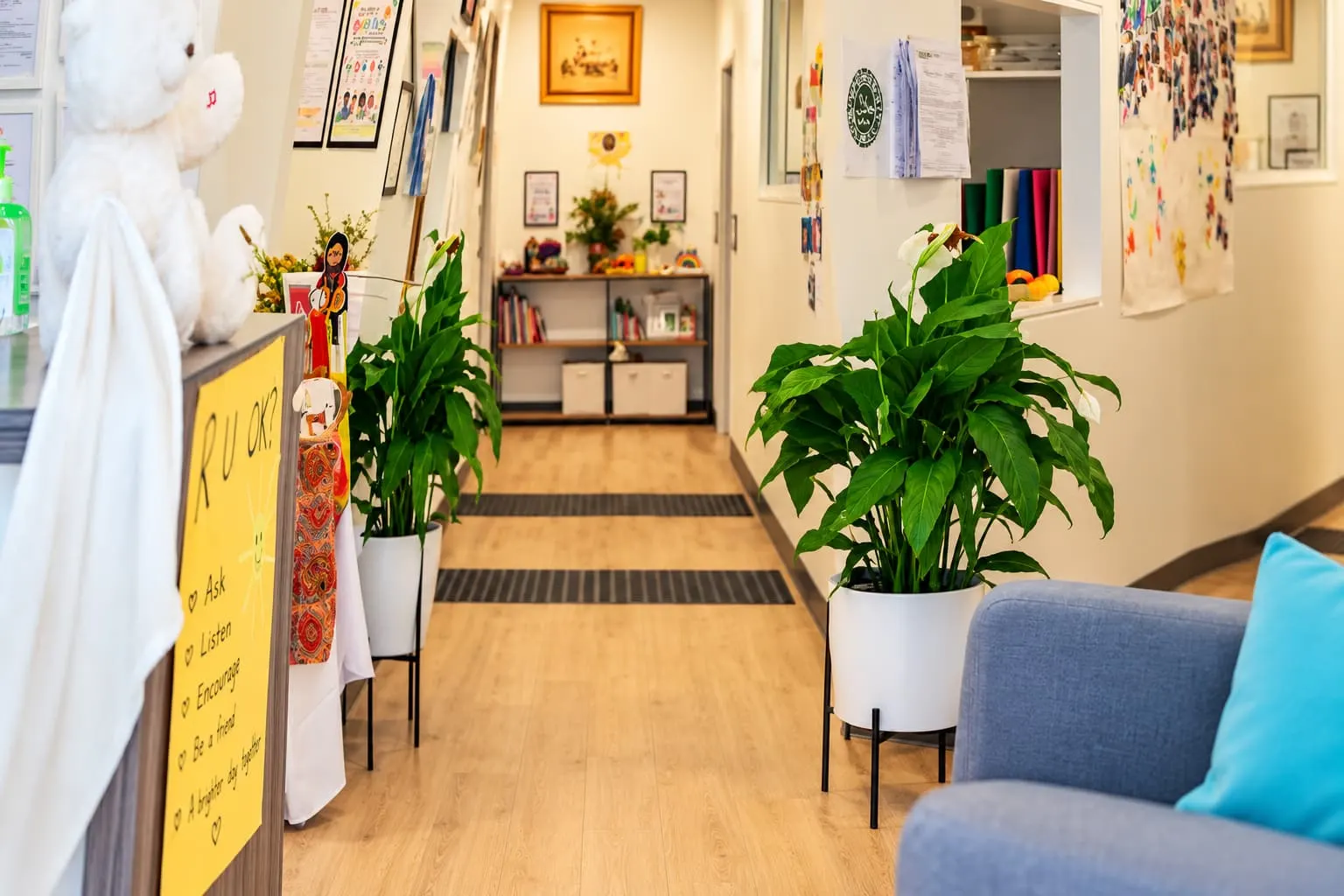 Centre hallway with a lounge, plants and children’s artwork
