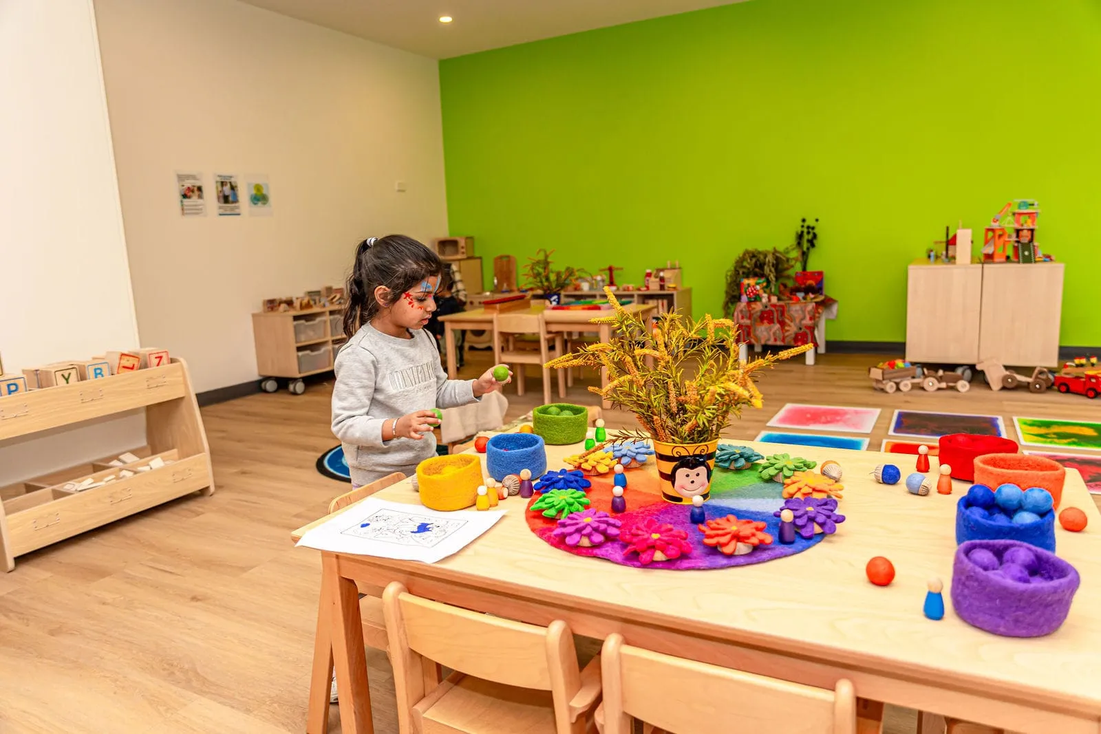 A child exploring the art table, at the YoMy Sunshine grand opening in Dandenong North
