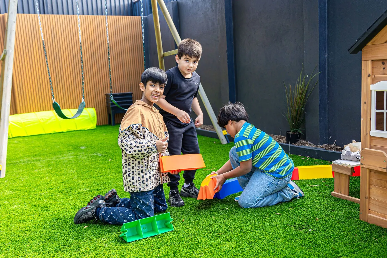 Children playing on the outdoor grass, at the YoMy Sunshine grand opening in Dandenong North