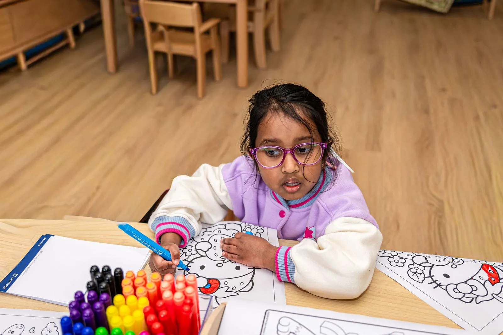 A young artist colouring in, at the YoMy Sunshine grand opening in Dandenong North