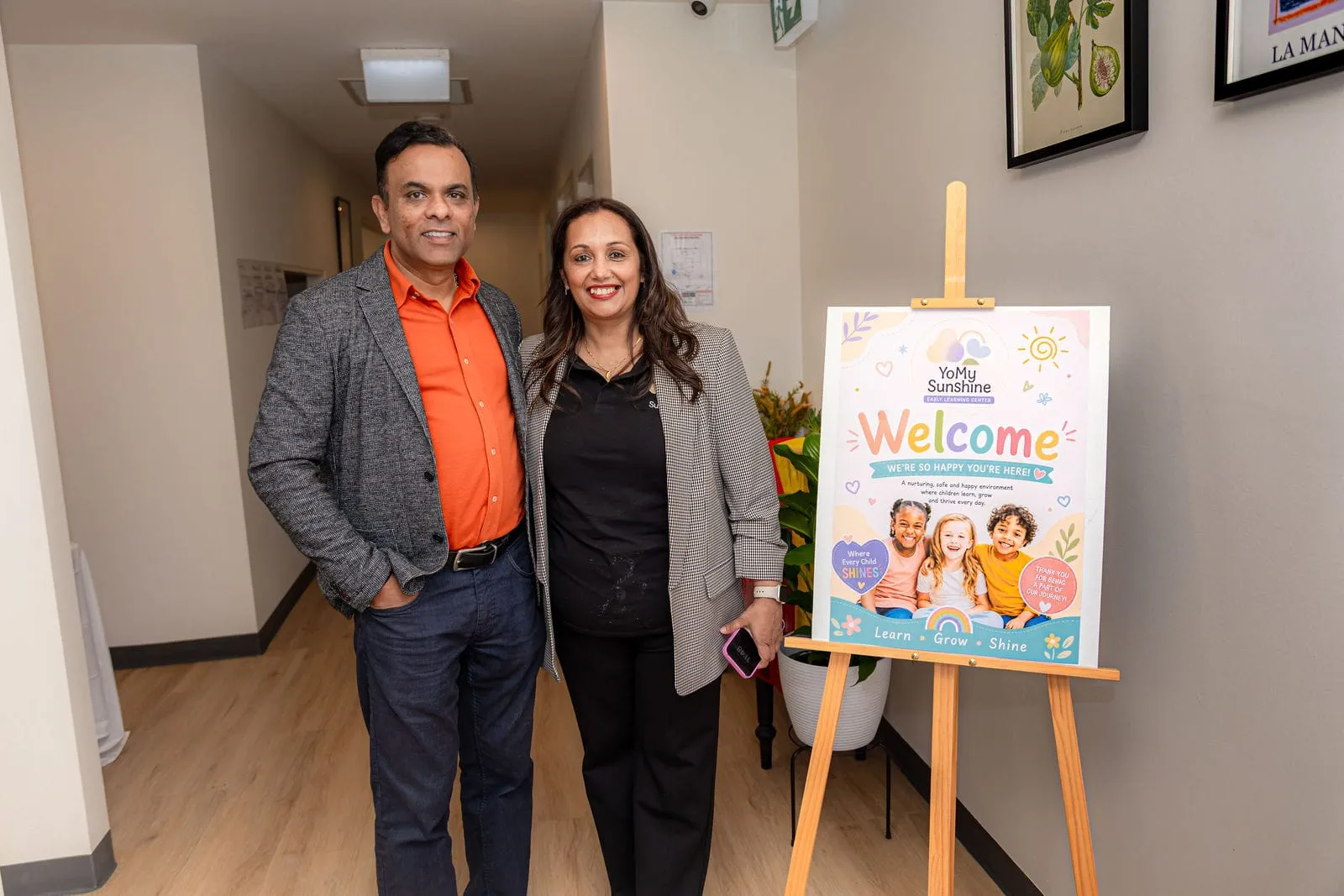 Guests beside our welcome sign, at the YoMy Sunshine grand opening in Dandenong North