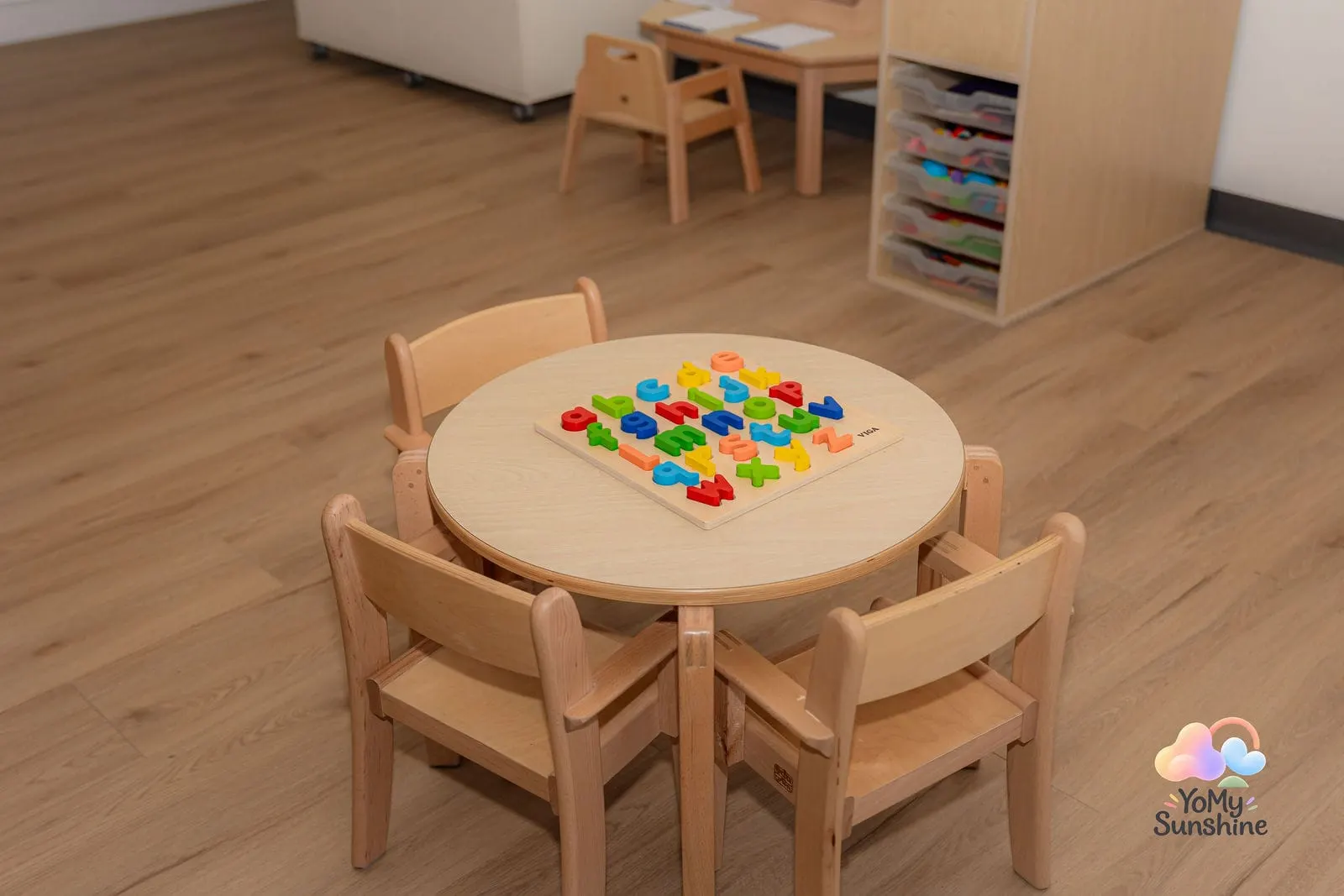 A colourful puzzle on a small round table with child-sized chairs