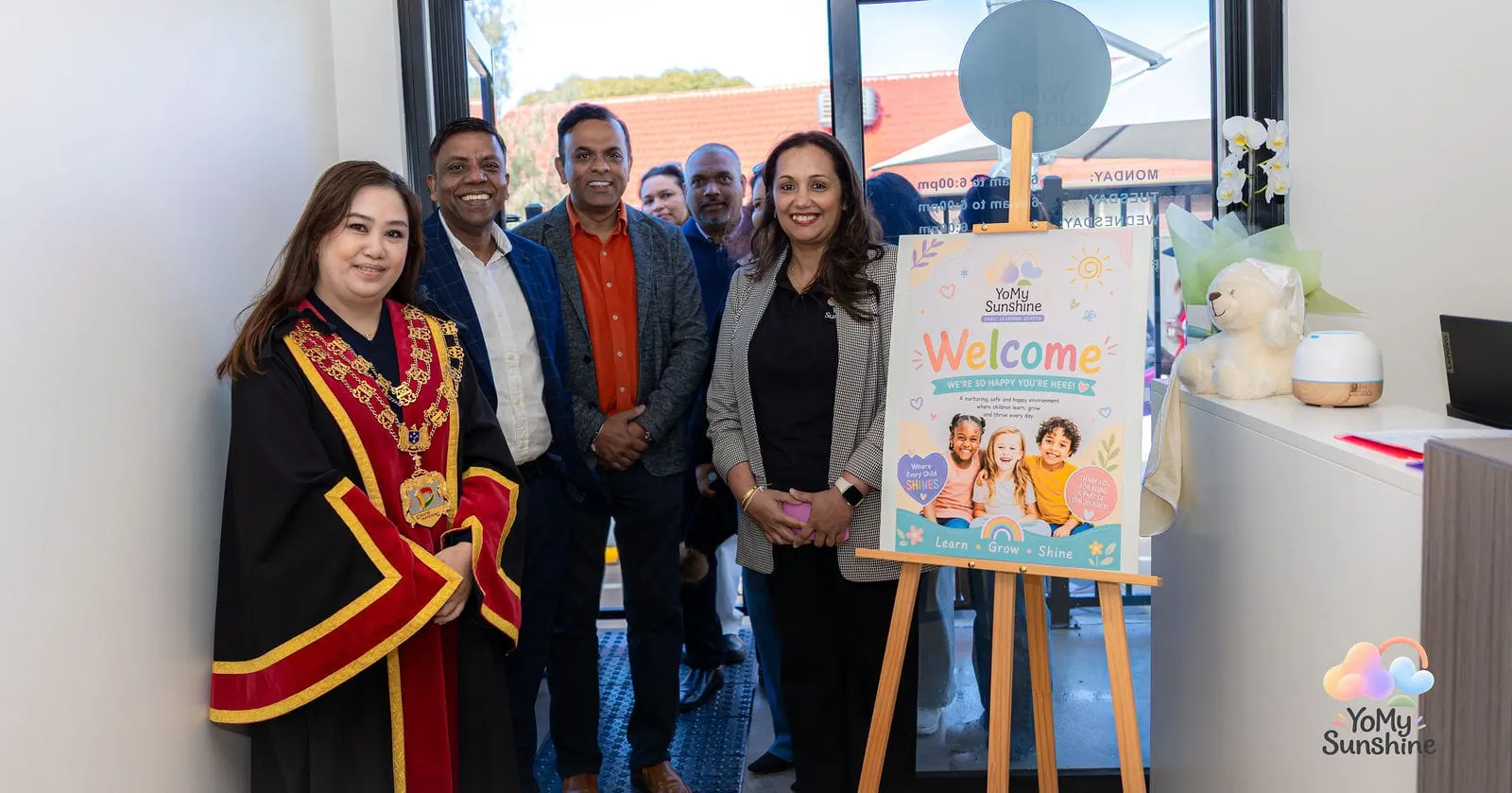 The Mayor of the City of Greater Dandenong with the YoMy Sunshine team beside the welcome sign at the grand opening